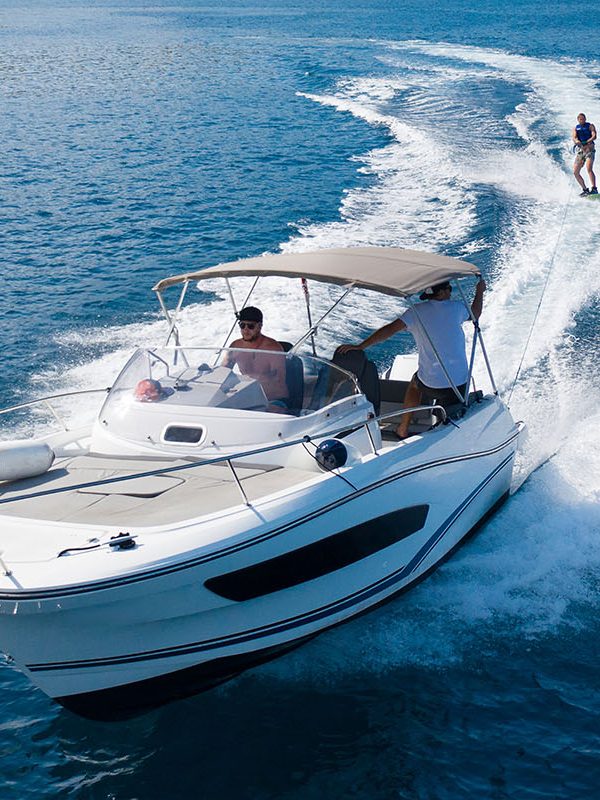 Speedboat with wakeboard rider on open sea